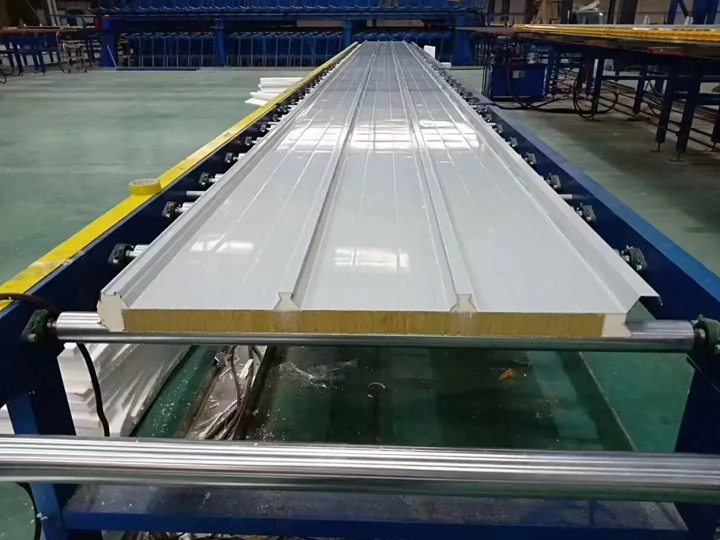 Insulated sandwich panels stacked and ready for shipment, showing panel core cross-section